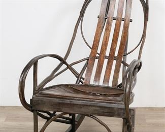        311	American Adirondack Bentwood Rocking Chair	"American Adirondack bentwood rocking chair. Early 20th century. Oak and bentwood twigs. Wear and scuffs to wood on back and seat. 

213/4"" W x 34"" D x 40"" H. 15 lbs."
