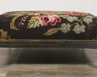        316	English Style Floral Embroidered Ottoman	"English style floral embroidered ottoman. 20th century. Floral embroidered upholstery, nailhead trim, spiraled legs on casters. Fraying, pilling, losses and wear throughout upholstery. Chips, marks, and losses to wood throughout apron and feet. Two feet on one side of ottoman are slightly loose, with repairs to one. 

43 1/2"" W x 43"" D x 20"" H

From the collection of a prominent Connecticut family."
