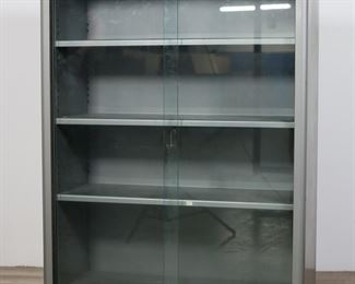        320	Steelcase Commercial Metal Bookcase	"Commercial metal bookcase by Steelcase. Grand Rapids, MI, 20th century. Three shelves with two sliding glass doors. Steelcase metal label on center of bookcase below glass doors. ""0260335"" on metal label on right side of base. Scratches, stains, scuffs  and marks to metal on top, sides and base of case. Rusting and wear to metal tracks of doors. Scuffs and light scratches to glass. Wear to shelves.

37 1/2"" W x 15"" D x 52 3/8"" H."
