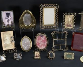        324	Lot of 17 Vintage Frames	Lot of 17 vintage frames. 7 brass frames with openwork and scrolling designs, 2 with leaf decoration,1 with flowers, 1 wood with art nouveau decoration, 1 small oval frame, 2 brass frames with tulip decoration, art deco brass frame, pair of silverplate frames with floral motif. Largest brass frame 9 x 6 3/4" (opening 6" x 3 3/4"); oval brass frame 7 1/2" x 5 3/8" (opening 5 5/8" x 4"); twig and leaf frame 8 1/2" x 6 1/2" (opening 6" x 3 3/4"); art deco brass frame 7 3/4"x 6 3/4" (opening 5" x 3 1/4"). All with minor scratches and losses to patina, some with later glass, pair of floral frames and art deco frame missing glass.
