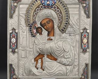        327	Russian Metal & Enamel Icon Madonna & Child	Russian icon, Madonna and child. Silver tone metal and enamel decorated oklad, gilt metal and enamel decorated halo. 15 1/8" x 12 1/2". Crack to oklad (metal cover) at nail at top.
