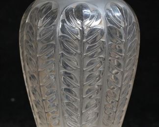        329	R. Lalique Tournai Frosted Glass Vase	Signed R. Lalique Tournai pattern frosted glass vase. Molded R. Lalique mark to the underside. 4 7/8"H. Light shelf wear to the underside.
