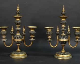        330	Pair of Bronze & Gilt Bronze Candelabra	Pair of bronze and gilt bronze candelabra. Openwork decoration, 3 lights, with snuffer finials. Each 9 1/4"W x 10"H (12 1/2"H with finials). Losses and scratches to gilt patina, wax residue.
