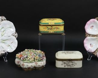        337	5 Piece Porcelain Lot Oyster Plates & Boxes	"5 piece porcelain lot. 3 porcelain boxes: Nicholas Haydon enamel decorated box with gilt metal mounts, 5 1/8""W x 3 3/4""D x 2 5/8""H; L.C. Japanese porcelain box, 4 1/8""W x 3 3/8""D x 2 3/8""H; box with applied porcelain flowers on lid, N with crown mark to the underside, 5 1/2""W. With 2 porcelain oyster plates, 1 with illegible mark to the underside, 10""W and 9 1/2""-diameter.

Nicholas Haydon box line to lid, line to corner of box, chips to interior; Japanese box scratches and discoloration throughout, oxidation and losses to patina on gilt metal, metal bent on one side; floral box chips to flowers throughout lid, chips to rim of lid, chips and repairs to base; round oyster plate chipped and repaired at rim, shell form oyster plate chipped at bottom edge, losses to gilt decoration on both."
