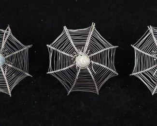        348	Set of 5 Silver Spider Web Place Card Holders	Set of 5 silver spider web place card holders. Silver filigree with center spiders, unmarked. Each 2 1/4"-diameter, 24 grams total. Some oxidation present, some slightly bent.
