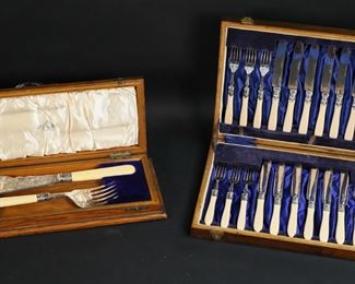        349	English Silverplate Fish Set & Serving Pieces	English silverplate fish set and serving pieces. 24 piece E.M. Dickinson, Sheffield fish set, 12 forks and 12 knives; 2 piece Ainsworth & Sons, Blackburn fish serving set, fish slice and fork. All silverplate with faux ivory handles, both sets in fitted wooden cases. Slice 12"L, larger wooden case 14"L x 9 1/2"W x 1 3/4"H. Minor wear to both cases, scratches to bottom of larger case, one fabric hinge on large case torn.
