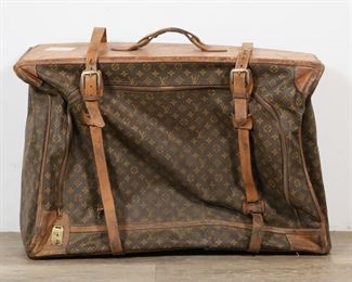        351	Vintage Louis Vuitton Luggage Bag or Suitcase	"Vintage Louis Vuitton luggage bag or suitcase. 20th century. Label on inside of bag states ""LOUIS VUITTON PARIS FRANCE MANUFACTURED BY THE FRENCH CO., USA UNDER SPECIAL LICENSE."" As is, with previous travel and airline tags, tears, staining, wear, scratches and scuffs throughout leather of bag. Staining and wear throughout interior liner of bag. 
32"" W x 9 1/2"" D x 22"" H."
