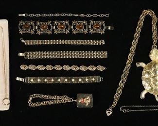        356	Grouping of Gold Tone Jewelry	Collection includes gold tone bracelets and necklaces. Faux gems and pearls, Whiting Davis snake bracelet, Trifari, Monet, Sarah Covington. One bracelet is broken, all with scuffs and scratches. Turtle pendant 5"L
