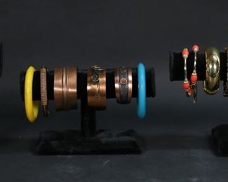        358	Grouping of Bracelets	Collection includes plastic, silver and gold tone, coral, wood, copper, some vintage, Capri. Blue and yellow bracelets each 2 1/2" inside diameter.
