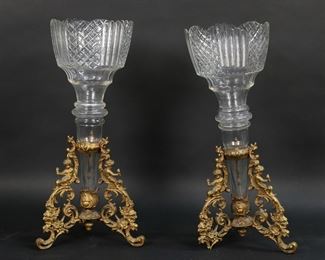        371	Pair of Gilt Bronze Epergnes	Pair of gilt bronze and glass epergnes. Bases with 3 legs with cherub decoration. Each 14 5/8"H. Both marked illegibly on the base. One missing foot, chips and fleabites to rim of one glass insert.
