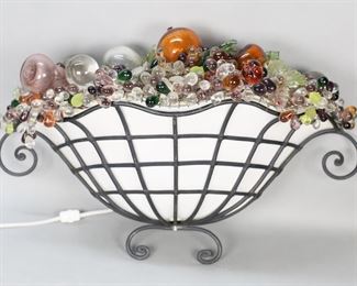        381	Cast Iron Sconce With Glass Fruit Shade	Iron electrified wall sconce with wire and glass fruit top shade. 25"L x 15 1/4"H. Chips to stem and cracks to center glass apple, wire cage holding fruit separating at one end and one center support detached.

