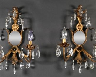        392	Pair Tole Foliate Sconces	Pair of 2 light tole sconces. Foliate arms and decoration, mirrored backs, crystal drops. Electrified. Each 15 3/4"H. Paint residue present on both.
