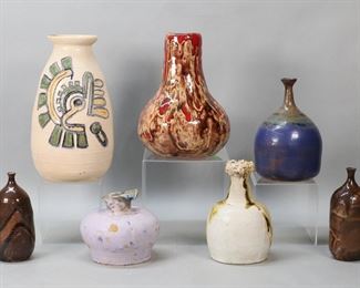        393	7 Signed Zabetti Art Pottery Vases	7 art pottery vases. 5 signed Zabetti, 2 unsigned. Tallest 11 1/4"H. Purple vase repairs to the underside, lines and crazing; red and brown vase no bottom.
