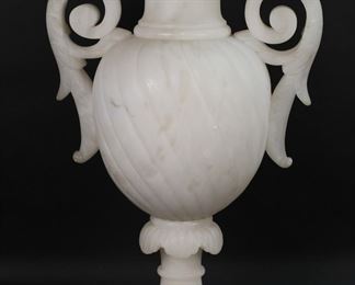        395	Neoclassical Style Alabaster Urn Form Lamp	"Neoclassical style alabaster urn form lamp. Spiraled urn with acanthus form handles with circular foot, all on  square base. Top with acanthus form molding is removable. Scuffs and marks to handles and body of urn. Loss and repair to alabaster on band above acanthus section of urn. Chips to alabaster on inner rim of urn and on corners of base. Lighting has been tested and is in working order.

14 5/8"" W x 9 5/8"" D x 24"" H. 44 lbs."
