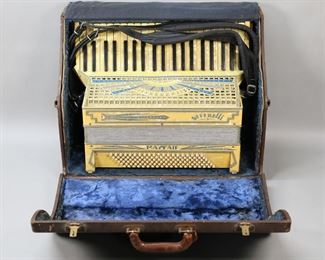        399	Serenelli Mayfair Piano Accordion With Case	Serenelli Mayfair model piano accordion, 120 buttons. Made in Italy etched on one side. With velvet lined case. Wear and fraying to cloth backing on accordion, celluloid peeling at piano and crack to celluloid above piano, crack to celluloid at top, minor loss to blue trim, 2 rhinestones missing; wear, staining and losses to velvet lining on case, losses to leather on case.
