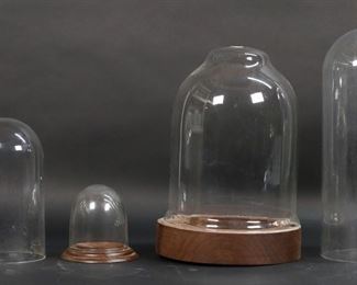        404	6 Glass & Plastic Domes	6 domes. 1 plastic dome (no base), 5 glass domes. 3 glass domes with bases and 1 with mismatched base. Tallest dome 13 1/8"H (no base).  2 with chips, cracks and roughness along bottom edge, bell shaped dome chipped along bottom edge,
