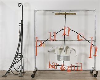        403	Punch Bar and Grill Hanging Restaurant Sign	"Hanging outdoor sign from the now closed Punch Bar and Grill on Broadway in Manhattan's Flatiron District. New York, 20th century. Cast iron frame and letters, sheet metal jester's hat, powder coat paint. Cast iron horizontal sign support with safety chain from original location is included. Chips and paint loss to letters. Scuffs, marks and wear throughout metal of jester's hat. Wear and rusting to cast iron support.

Sign: 73""L x 34""W (widest point on hat), 69 1/4"" H to top of hardware. Support: 84""L x 23 7/8""H x 23 3/8""W."
