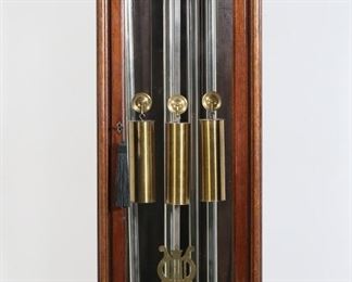        410	Franklin Electric Grandmother Clock	"Franklin electric grandmother clock. Early 20th century. Mahogany case, 3 brass weights, four chimes, and pendulum. Original key is included. Slight separation of bottom panel of wood from case. Scuffs, scratches and wear to wood throughout case of clock. Chip to wood on back right edge of case. Tears, splitting, and stiffening to electric plug and cord of clock. Longest chime is separate from original cord which is frayed. Wear to fabric of removable panels. An additional clock face, along with pins and hardware from clock mechanics,  are included. 

16 13/8"" W x 13"" D x 71 1/4"" H."

