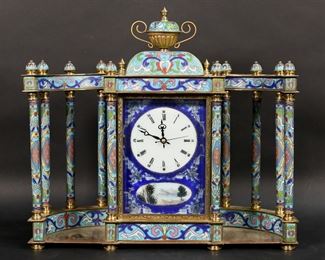        421	Cloisonne Colonnade Clock	Cloisonne and brass colonnade mantle clock in the French style.. Clock running, timekeeping untested. Discoloration and losses to brass. 13 1/4" W, 11 3/4 "H

