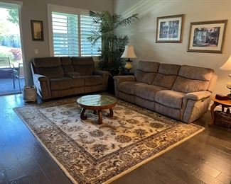 Couch & loveseat w/ recliner on each end.
2 Wool rugs (8x10). 2 solid wood end tables
Large faux palm tree. 2 large lamps, wall pictures 