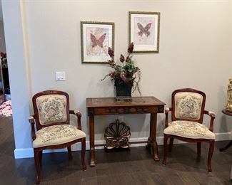 George and Martha Washington chairs
Faux marble table floral decoration on table. 2 butterfly framed prints .  Decorative Fleur de lis 
