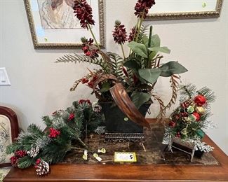 Faux marble table, Christmas sleigh and Christmas sprigs. Floral arrangements and 2 butterfly pictures 