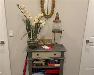 Home goods cabinet ( bought for $150. Glass ornamental vase and stand, orchid arrangement. Books below most just $2
2 small floral pictures.