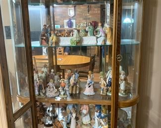 Beautiful oak curio full of a Holland mold Nativity set and a Home Interiors Last Supper set and other collectibles