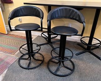 Trica black swivel bar-height pub chairs with footrests