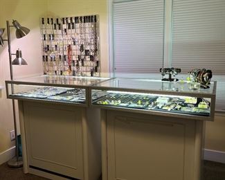 Lighted jewelry cases are for sale. These can be moved after the sale is concluded.