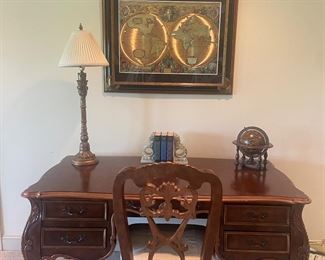 The side of this desk is ornate and beautiful 