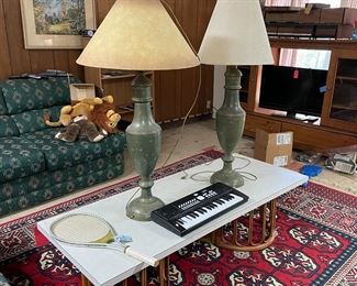 Large lamps, bases match, coffee table, entertainment center, couches, rug, TV