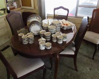 Dining table, has 3 leaves and 6 cane back chairs. 