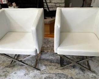 Safavieh  faux leather director style  armchairs with chrome bases.