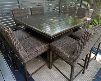 Outdoor high-top firepit table with eight chairs from Ashley Funiture