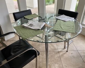 Chrome and glass table with 5 Black and Chrome chairs