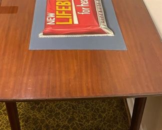 Mid-Century Dining Table with Glass Topper. Lifebouy for Health Advertising Poster is Removable. Measures 60" W x 36" D x 30" H with 27" Clearance. Photo 2 of 3.