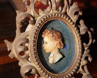 Antique iron scroll picture frame with carved portrait bust