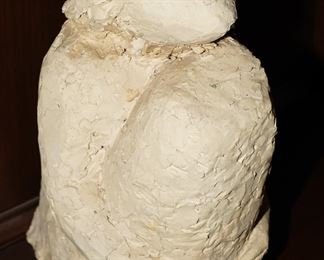 Stone sculpture on a person holding their knees