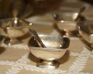Sterling salt dishes with sterling spoons.