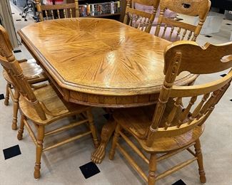 Oak oval table with additional 18" leaf, 6 chairs.  69" x 49".