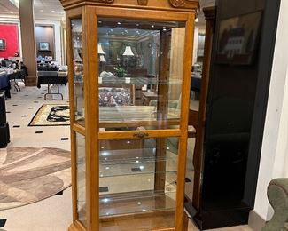 Oak lighted curio with sliding door