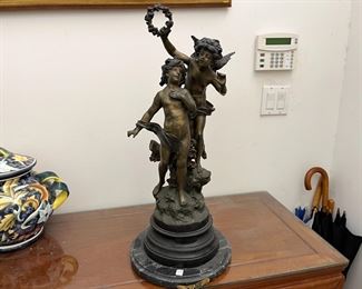 Bronze, 26.5"h, "Love Song" by Auguste Moreau, the third son of sculptor and painter Jean Baptiste Moreau, Auguste initiated himself to sculpture along with his older brother Mathurin. In 1861, he made his debut at the Salon, where he would exhibit regularly until 1913. His subjects were primarily genre scenes, pastorals, and allegories; his style was realistic and graceful, revealing his relation to the other members of the Moreau dynasty.
