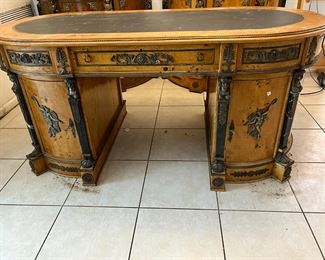 French Empire Style Double Pedestal Brids Eye Maple Desk: Oval Top with inset banded leather writing surface, 3 drawer over knee hole & 2 shaped doors. Rightly enhanced over all with attached Ormolu decoration. 32h x 71w x 35d
