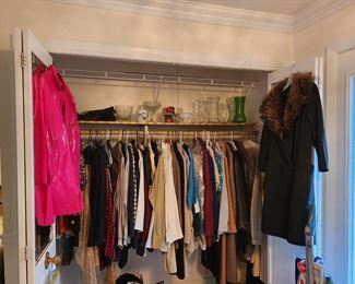 There are vintage clothing mixed in with newer clothing in each closet