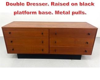 Lot 240 Danish Modern Teak Low Double Dresser. Raised on black platform base. Metal pulls. 