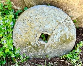 antique grinding stone (cracked)