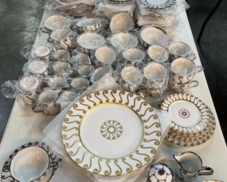 Hand painted gold and platinum dinnerware by Marc Blackwell