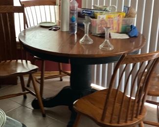 oak top table with two extra leaves and four oak chairs