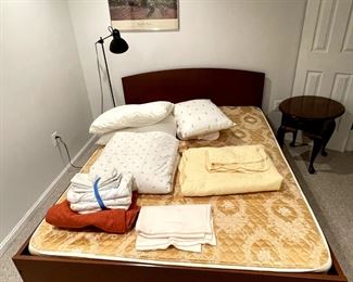 Queen-size bed and linens.